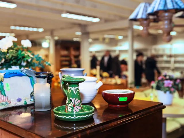 Glassware and vintage dishes on a thrift store table